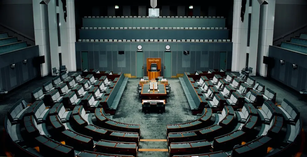 dark shot of the Australian parliament's empty seats